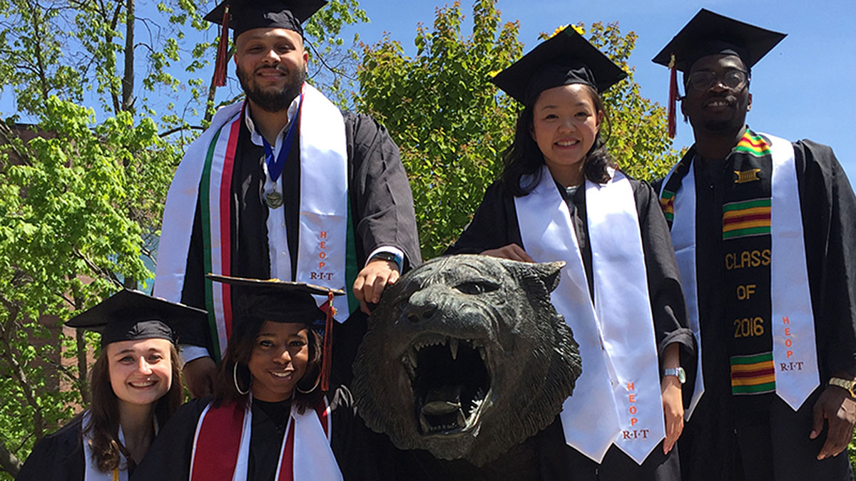 HEOP students standing around RIT tiger.
