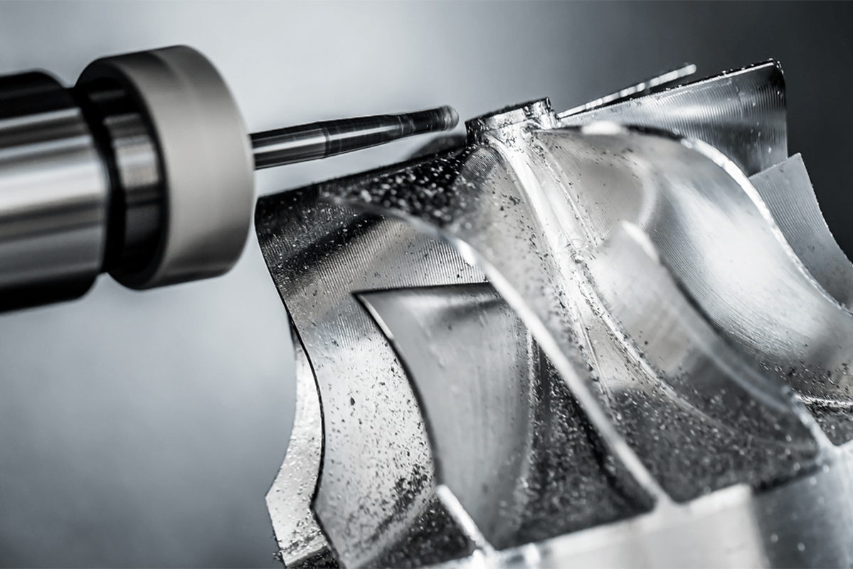 Metal drill shaving a piece of metal into a spiral drive