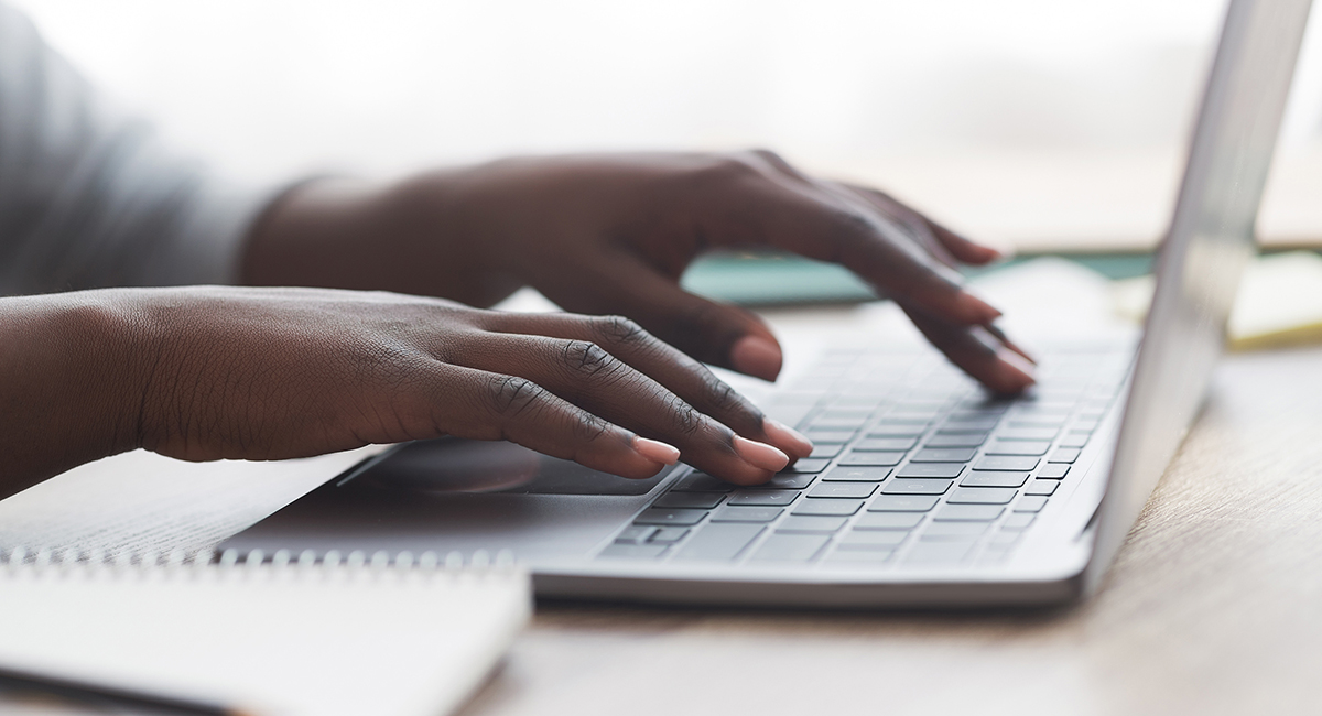hands typing on laptop