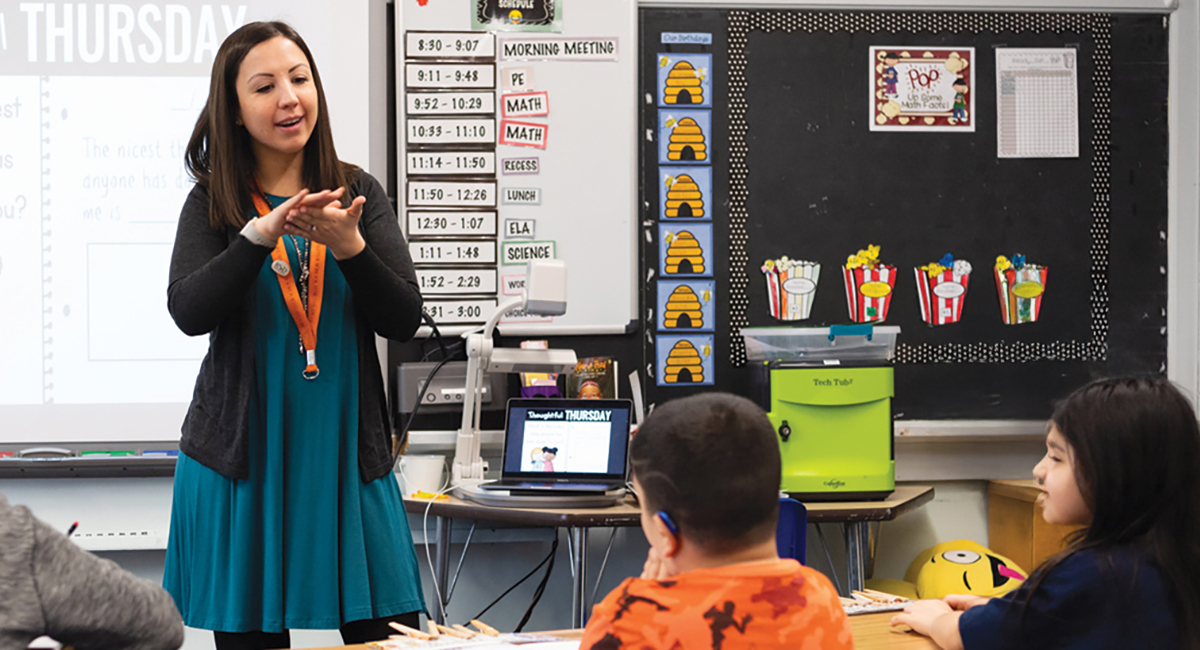Photo of teacher/interpreter and students in classroom