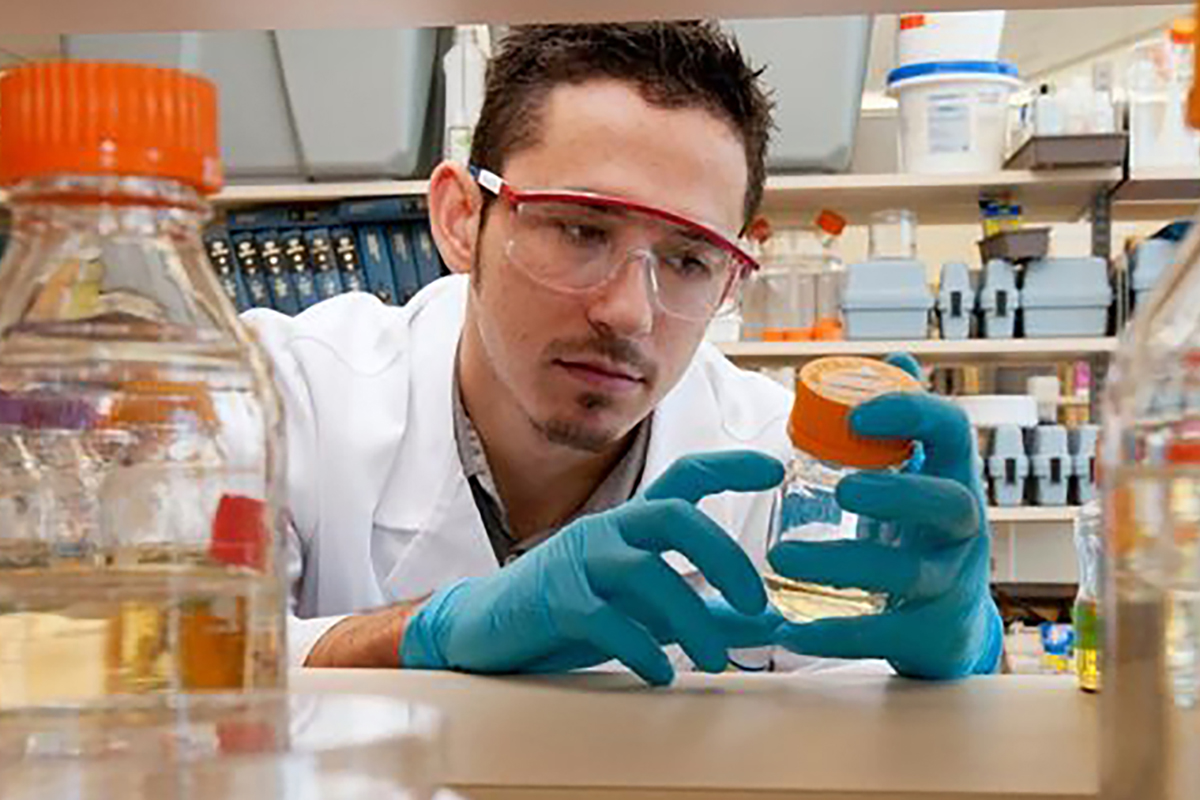 Student in lab with beakers and chemicals