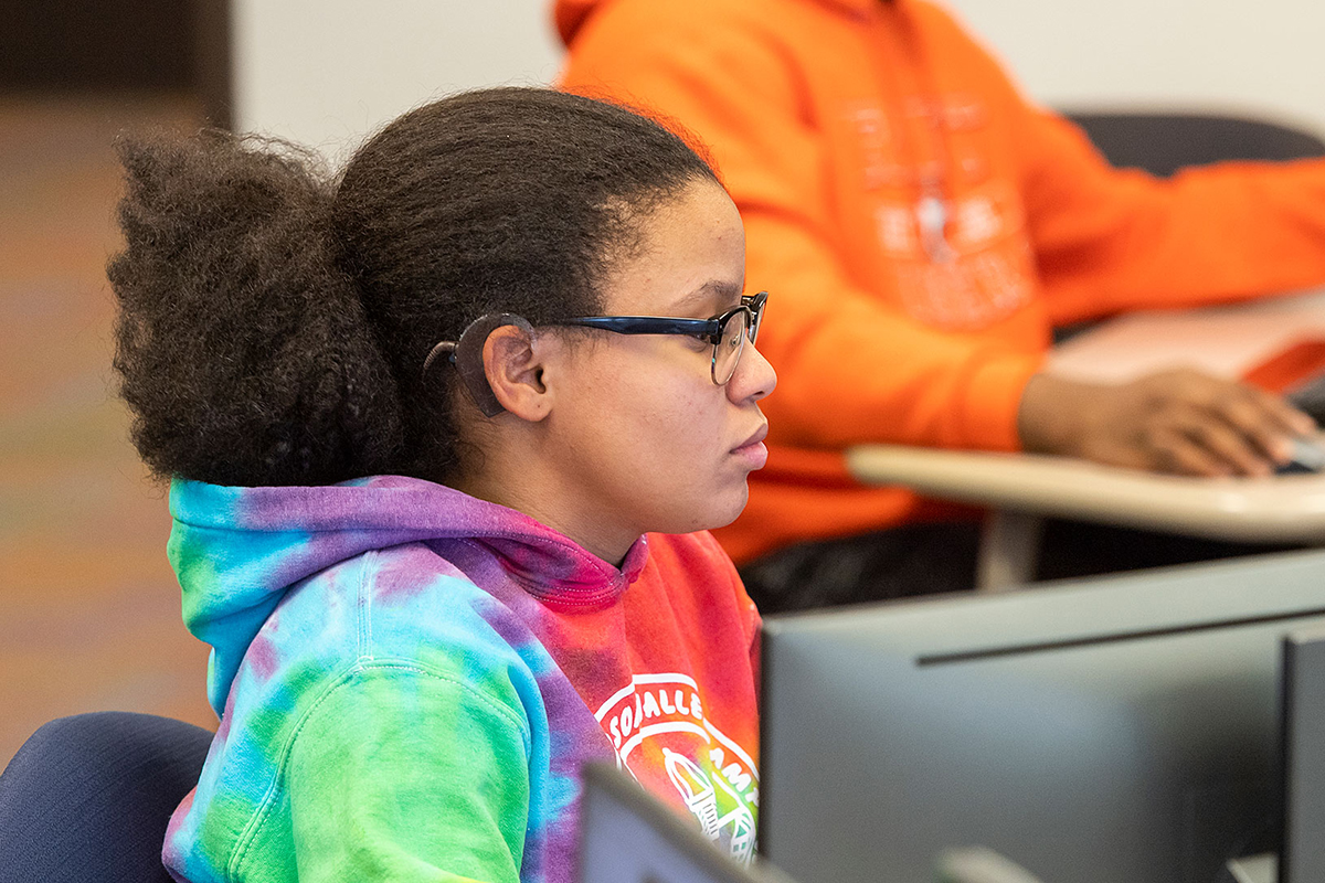 A young female student works at a compter