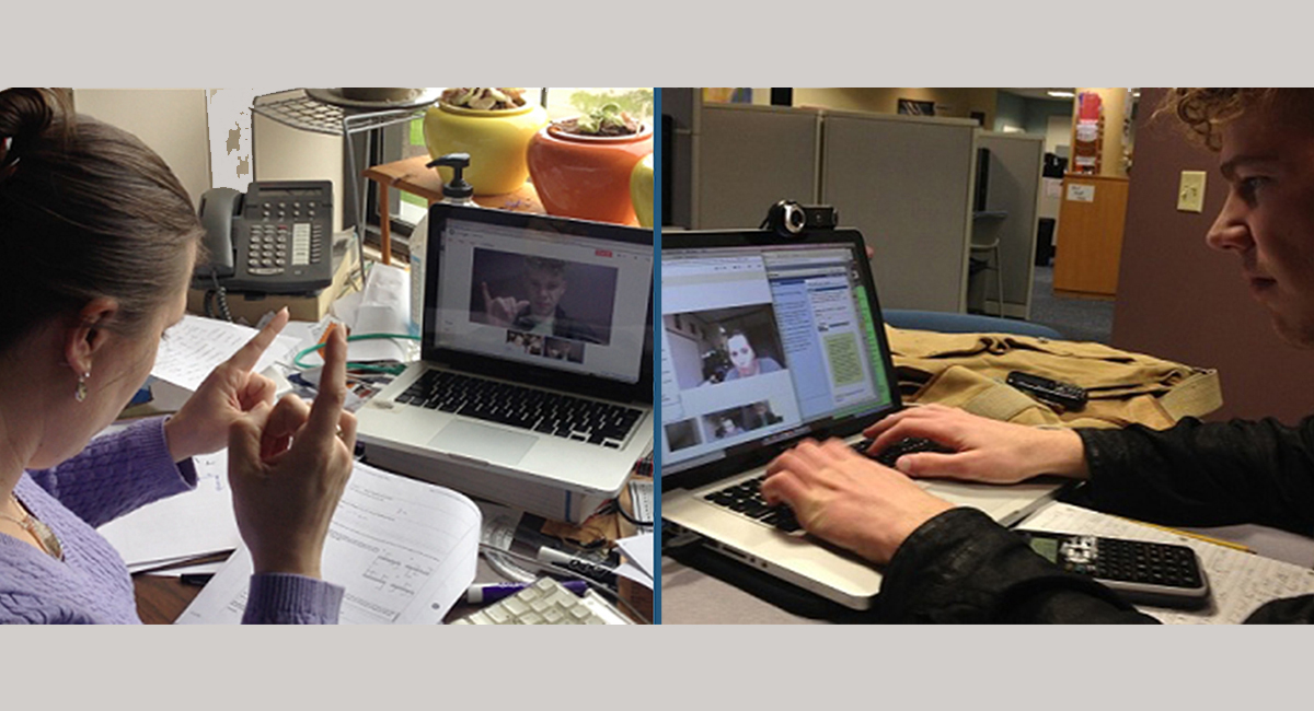 Two people communicating virtually using laptops