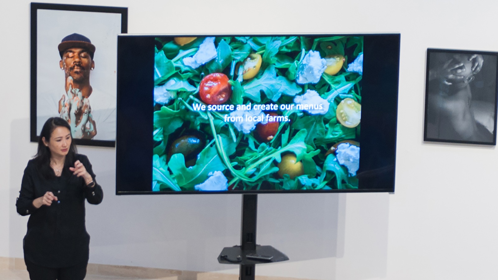 Woman giving lecture with various screens of info around her