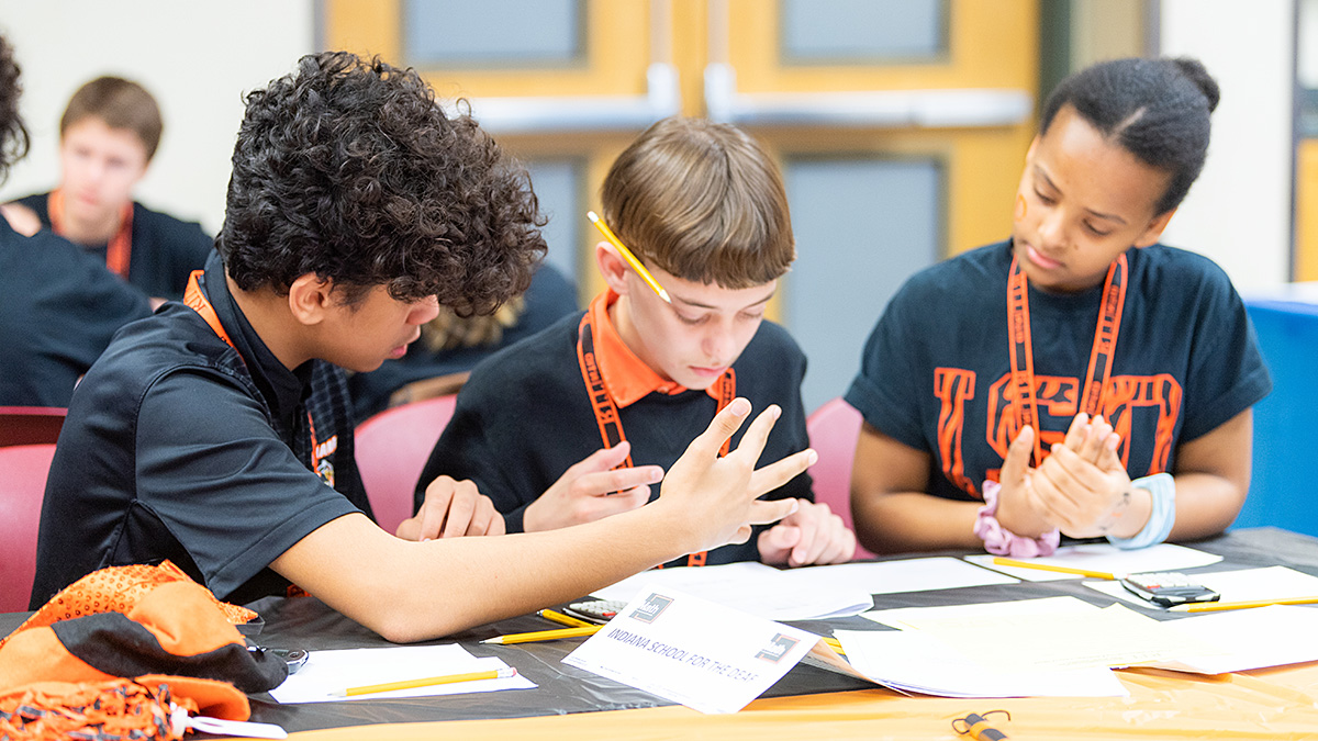 Three students working together to solve a math problem