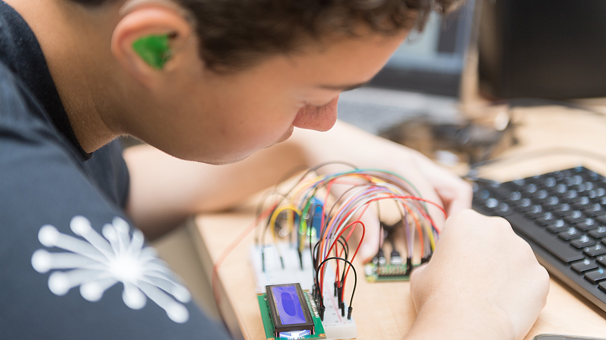 A student assembling a circuit board