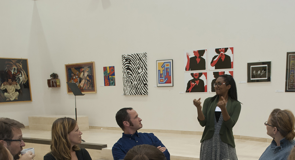 Woman signing to group at RADSCC banquet