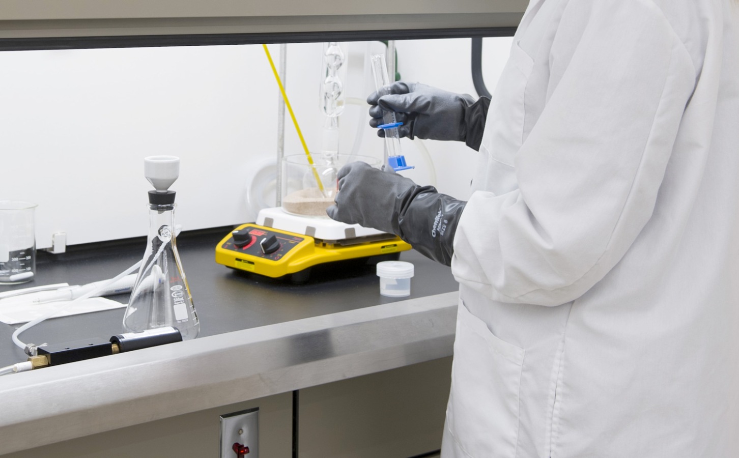 Person handling vials in a lab