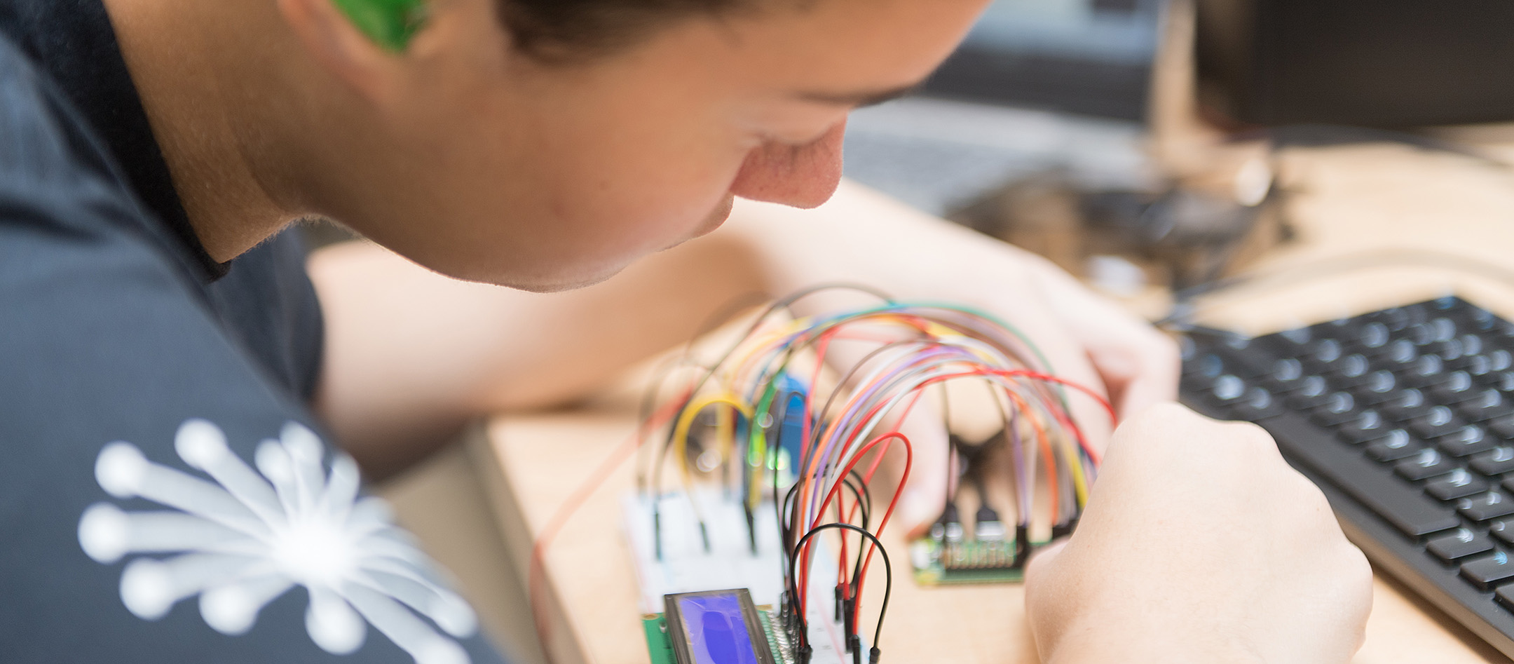 A student assembling a circuit board