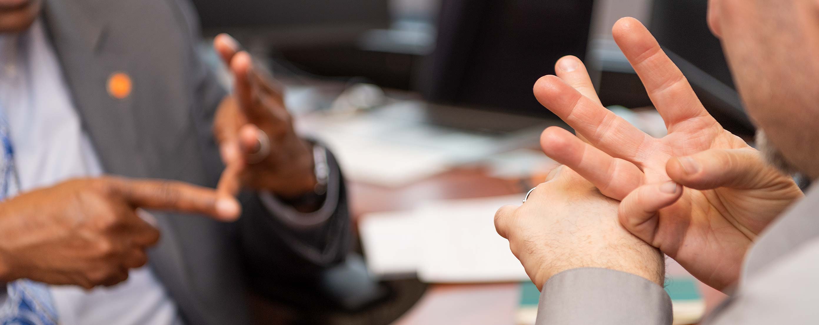 Close-up photo of hands signing