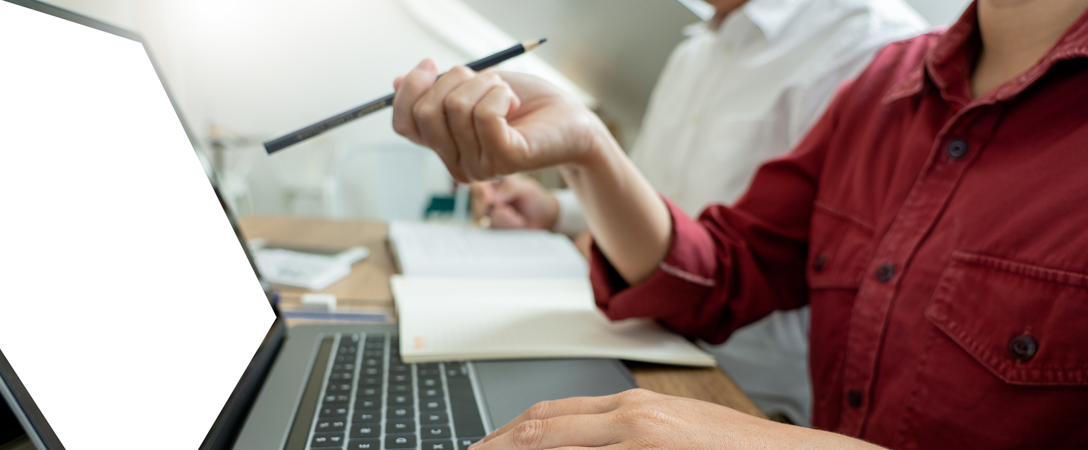 Student pointing pen and indicating need for assistance