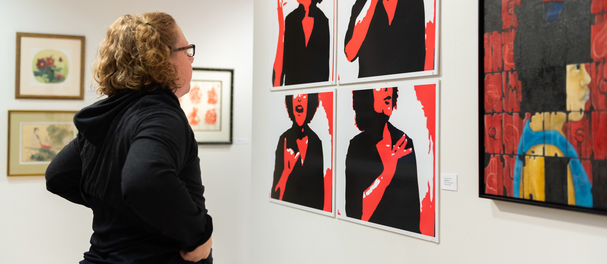 A student looks at artwork in the Dyer Arts Center