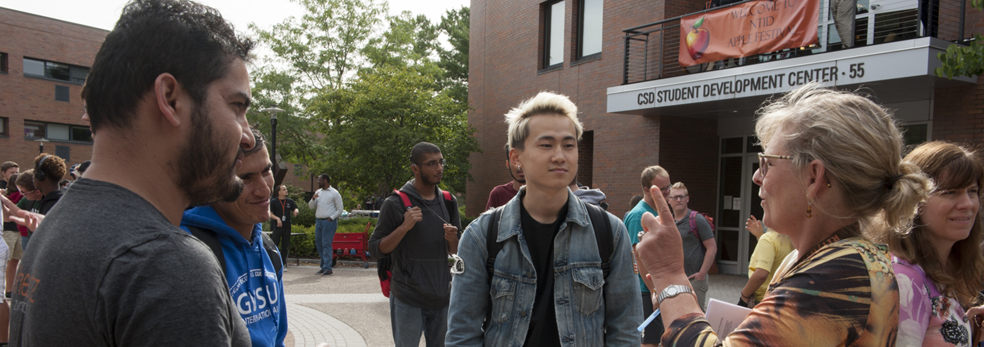 Mary Karol Matchett conversing with students in the quad