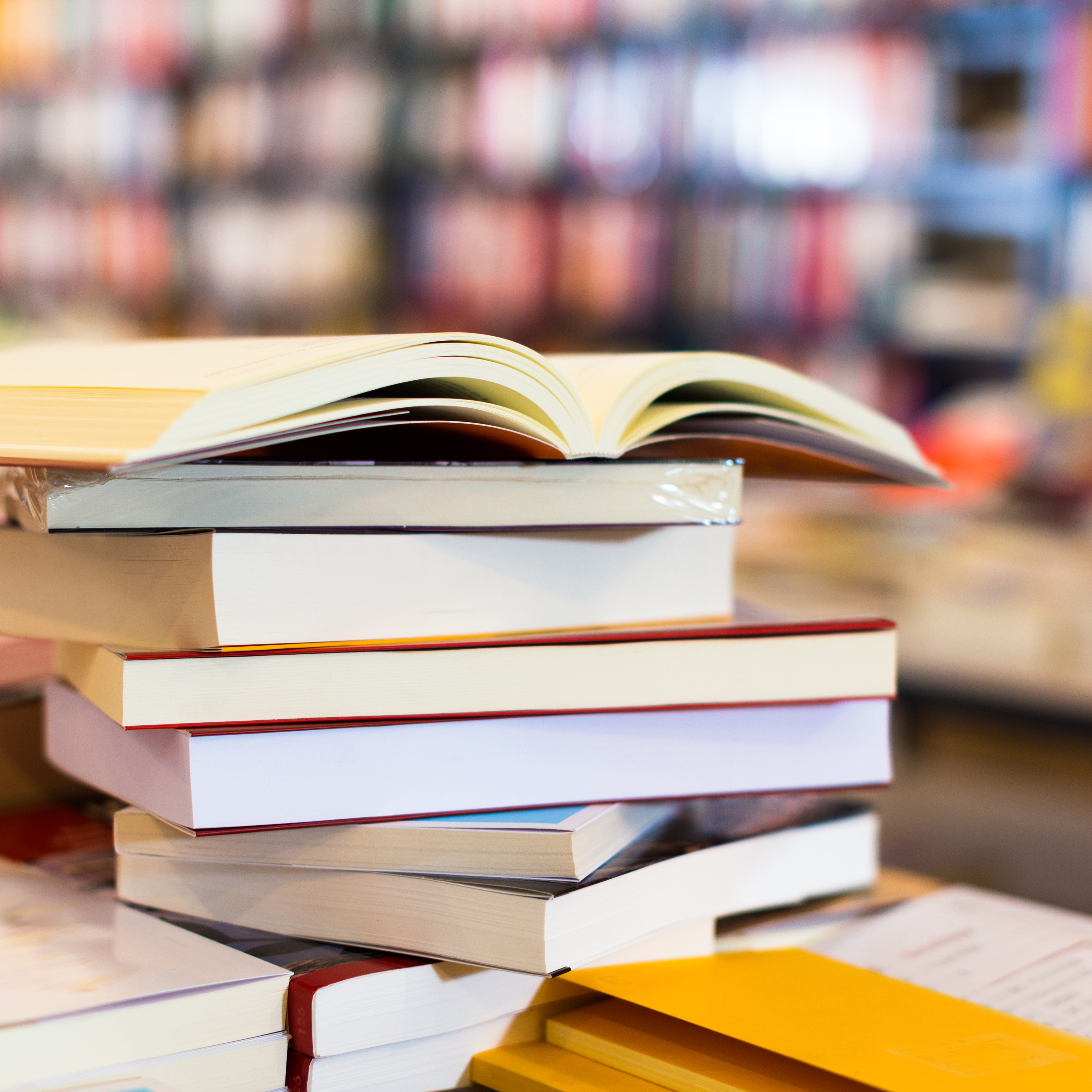 Stack of books lying on table in bookstore