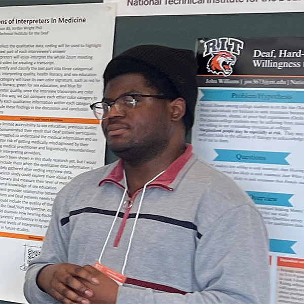 Adedotun presenting at the research symposium