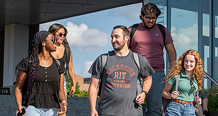 A diverse group of students walking and chatting.