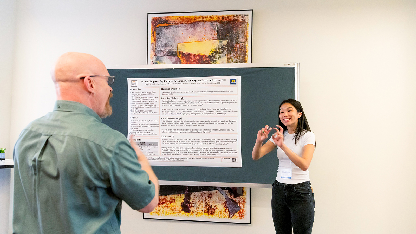 Student presenting to viewer at poster session