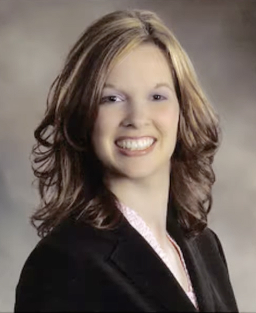 Photo of Pamela Siebert woman standing, long dark hair wearing dark suit jacket and light colored blouse