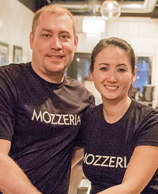 Russell and Melody Stein standing together in their pizza shop