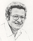 Photo of man with curly hair, glasses. wearing light colored shirt open at neck.