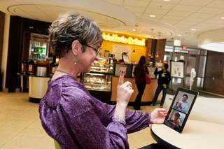 Woman signing to camera on tablet, with split screen of communicants.