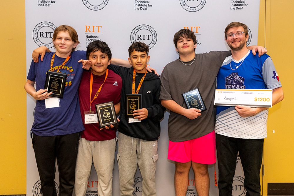 First-place Tiger Gaming League team 'Rangers' holding awards and a $1,200 prize check in front of an RIT NTID backdrop.