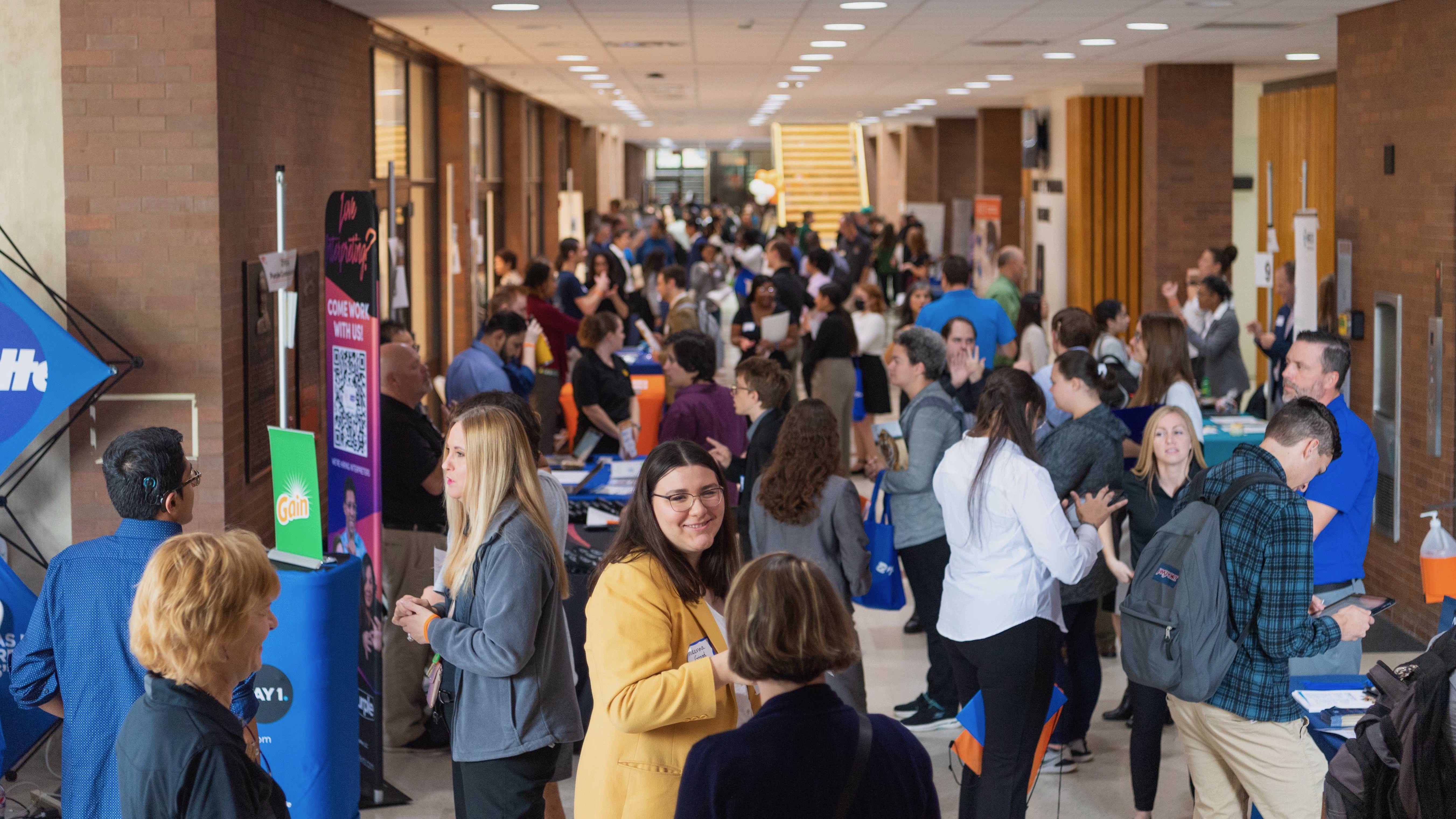 Students gather in hallway and meet with recruiters.