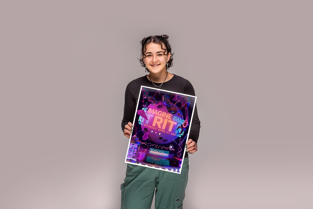 Jessica Hall holds her winning poster design for this years Imagine RIT Creativity and Innovation Festival