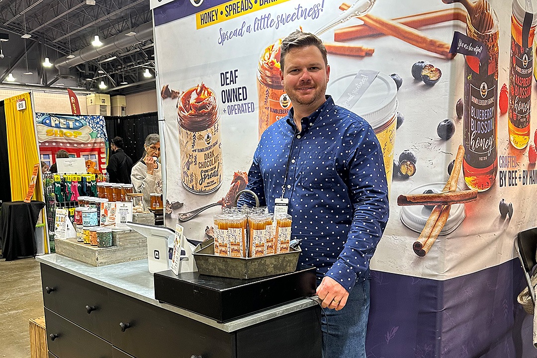 Jon Mosholder stands behind a display of his company's products