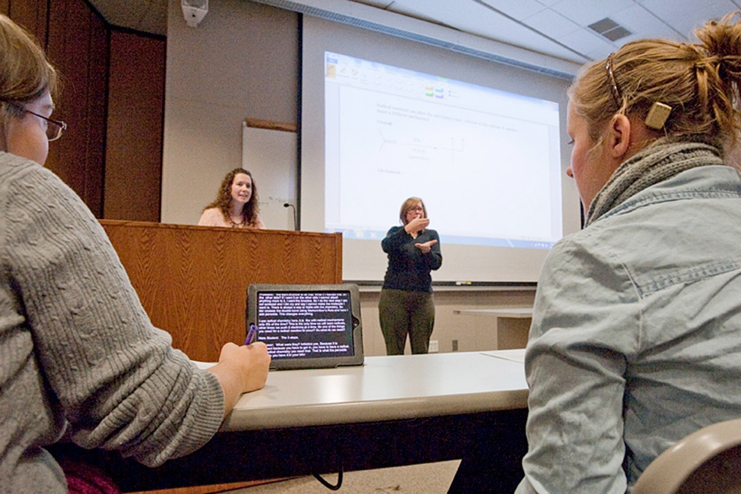 captionists working in a classroom