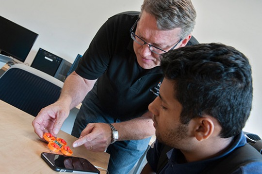 Professor talking about product with student