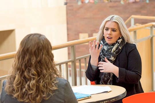 Andrea Sinden signing to another person.