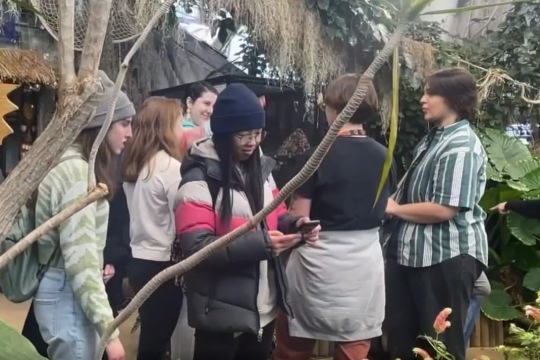 college students in a butterfly sanctuary.