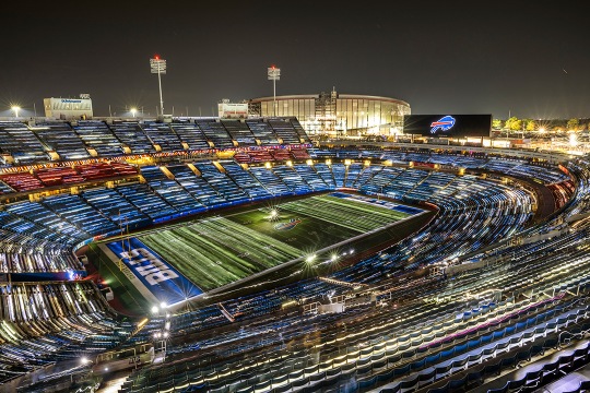 Buffalo Bills Highmark Stadium is shown lighted in an arial view.