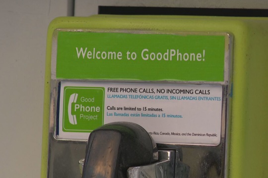 A close up photo of one of the free GoodPhone installations. Above the phone receiver a sign reads Welcome to GoodPhone and provides brief instructions in both English and Spanish.