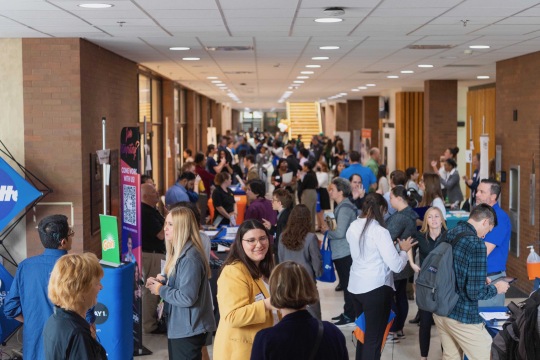 Students gather in hallway and meet with recruiters.