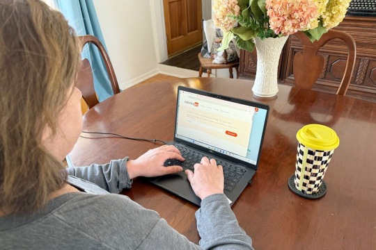 photo of woman typing on laptop
