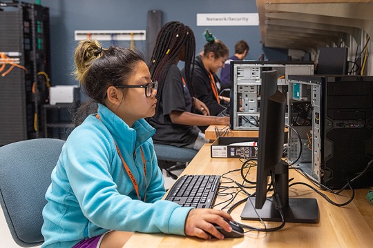A student working on a computer in a lab