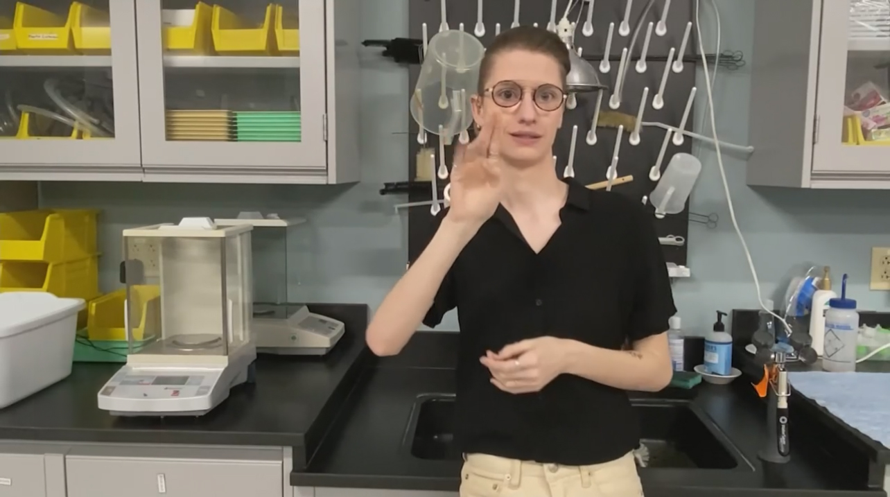 Photo of Ashley Gleason in lab signing