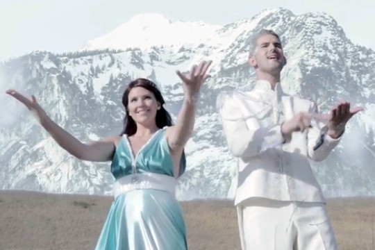 People posing in front of mountains