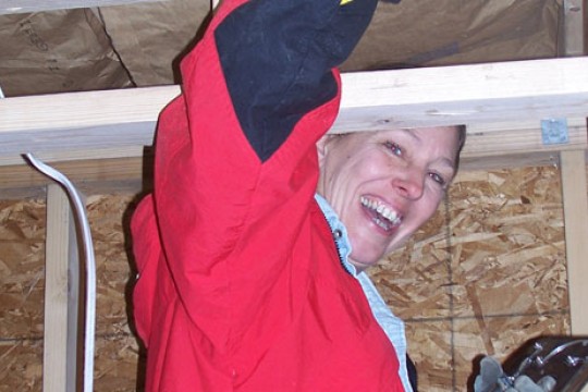 Staff Assistant nailing in boards to a wall