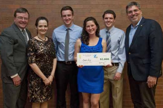 People posing with check at event