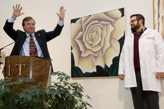 People speaking at podium on stage 