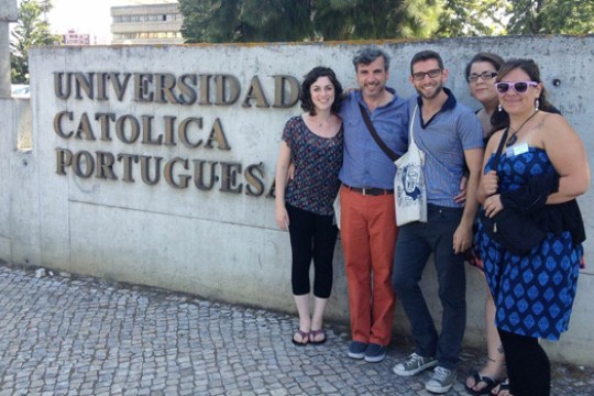 People posing next to "Universidad Catolica Portuguesa"