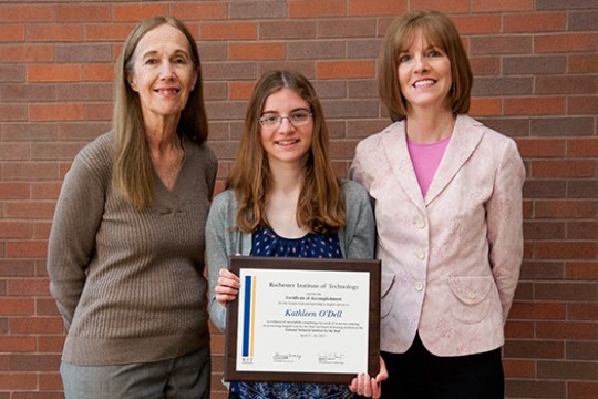 Family posing with award