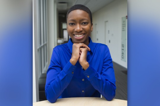 Person posing for camera at table