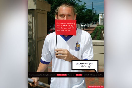 Person posing for camera with flag infront of mouth