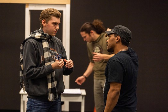 students rehearsing fight scene for a play.