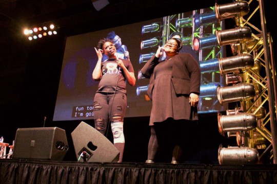 comedian Leslie Jones on stage with an American Sign Language interpreter.