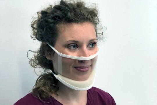 woman wearing clear fask mask.